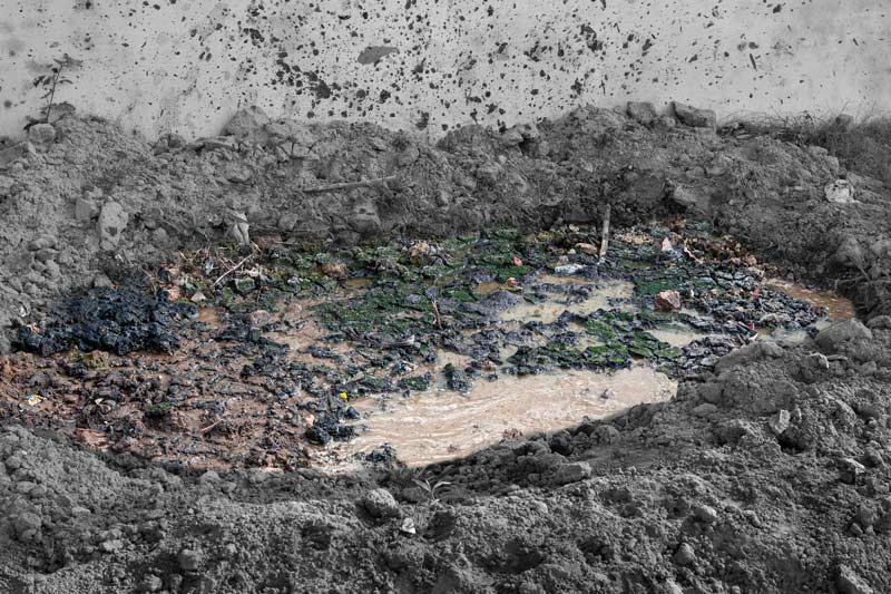 An open site with freshly disposed untreated fecal sludge and effluent from septic tank in a peri-urban residential colony in Bareilly city, Uttar Pradesh